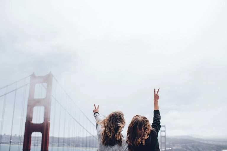 travel buddy, peace sign with golden gate bridge in view.